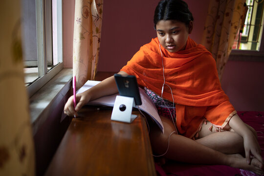 Teenage girl taking online classing during lockdown