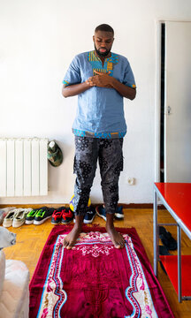 Young Black Muslim Praying At Home.