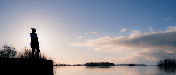 Silouhette Finnish girl standing on on natural piers