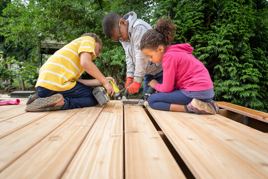 Siblings building a deck