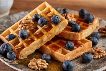Waffles with blueberries, walnuts and maple syrup