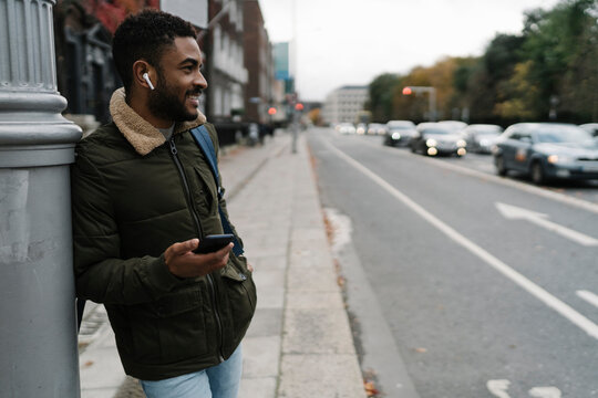 Man at the Bus Stop With Phone