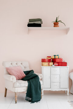 Stylish room with stack of gifts