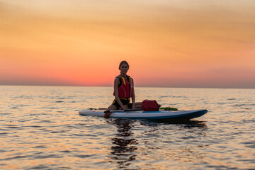 Naklejka na ściany i meble Kayaking. Woman traveling by kayak