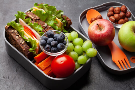 Healthy school lunch box with sandwich and fresh vegetables