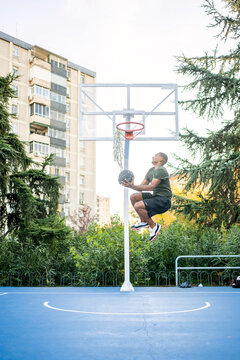 Young Man Making A Basketball Dunk.