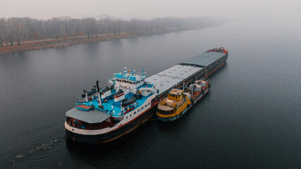 Top-view of two cargo ships like a child and it's parent