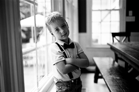 Cute young boy wearing suspenders and a bowtie