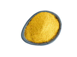 Nutritional yeast in blue plate isolated on white background.