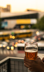 person holding a glass of cold beer