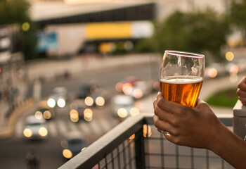 person holding a glass of cold beer