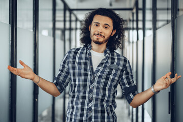 Portrait of confused clueless handsome young man with raised arms