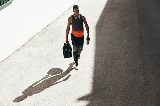 Fit Man Walking Outside With A Gym Bag