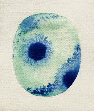 Malachite color dot with blue ink inside it on textured paper