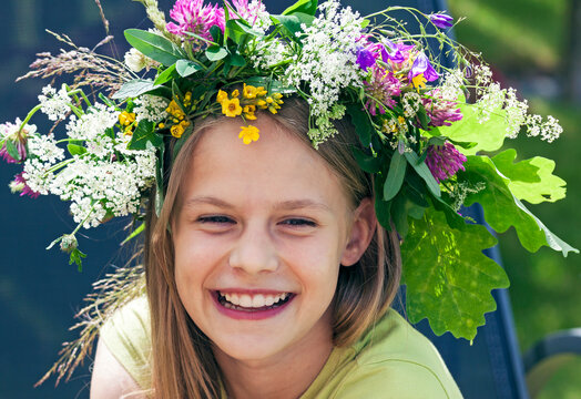 Happy smiling teenage girl with flower wreath