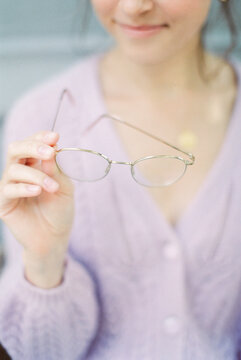unrecognizable woman holding eyeglasses
