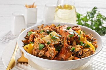 braised Rabbit with potatoes in a white bowl