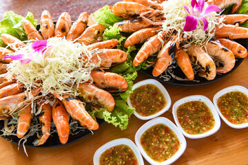 Grilled shrimp prawn with fresh vegetable and seafood sauce,  shrimps grilled serve on tray - seafood buffet Thai food