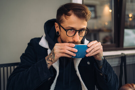 Man drinking coffee outside