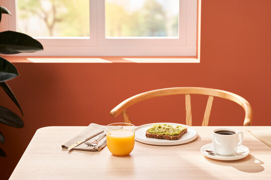 Juice and coffee near toast for breakfast