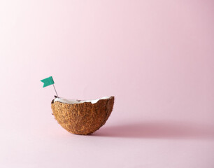 Tropical beach concept made of coconut and green flags. Creative minimal summer idea