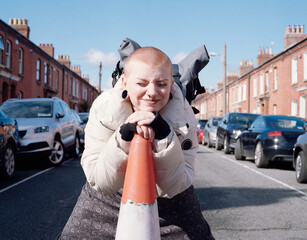Woman Stopping Traffic Using a Cone