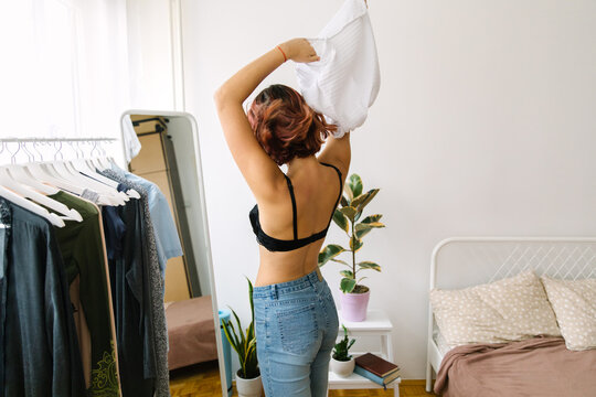 Portrait of a young woman getting ready in front of a mirror