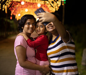 Girls enjoying mobile photography with illuminated backdrop