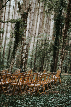 wooden folding chairs in the woods for wedding