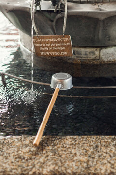 A ladle being used at a chozuya in a temple in Tokyo, Japan.