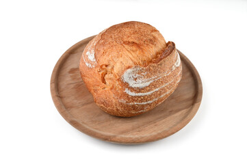 Round homemade bread on a wooden plank, on an isolated background