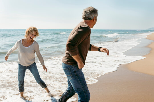 Mature couple propose at the fall beach morning
