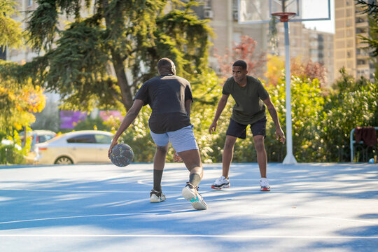Two Friends Playing Basketball.