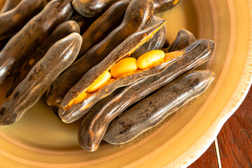 Boiled pods of Mucuna pruriens are placed on a plate.