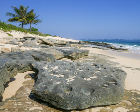 Landscape view of scenic Marosi beach with big eroded flat rocks, Lamboya, Sumba island, East Nusa Tenggara, Indonesia