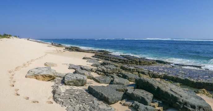 Seascape with footprints in the sand on Marosi beach with beautiful rocks, Lamboya, Sumba island, East Nusa Tenggara, Indonesia