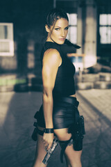 Lara Croft Tomb Raider action movie cosplay costume photoshoot with guns and weapons brunette female model	 - obrazy, fototapety, plakaty