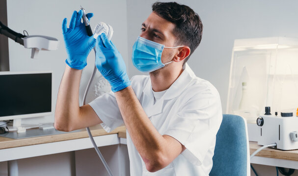 Dental Technician Making New Dental Prosthetics In Laboratory.