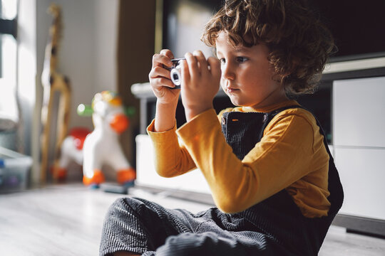 Boy playing with digital camera