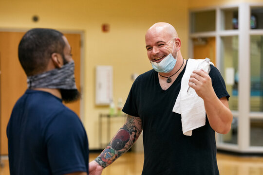 Gym: Male Friends Laugh After Stretch Class