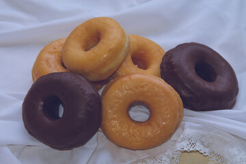 group of sugary and chocolate donuts on the table