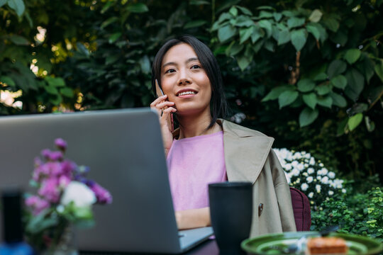 An Asian Woman Talking on the Phone