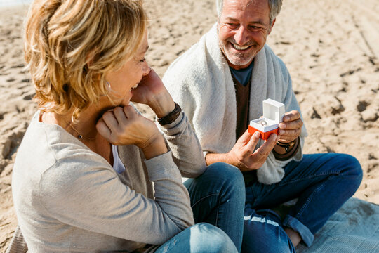 Mature couple propose at the fall beach morning - Powered by Adobe