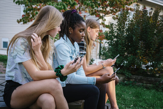 Group of diverse teenage girls with mobile devices