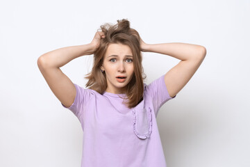 Fototapeta premium close up portrait of worried and anxious girl, grab head and panicking, staring alarmed, dont know what do