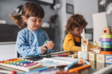 Girl drawing a picture with his brother
