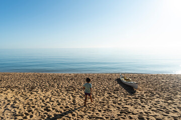 Boy, beach and sun, New Zealand.