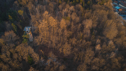 Fototapeta na wymiar Early morning drone panorama photo of abandoned ski jump tower in Mostec, Ljubljana. Relic of an old ski jumping hill in the Slovenian city.