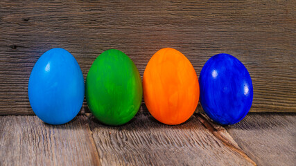 Easter eggs on dark wooden table against wooden background