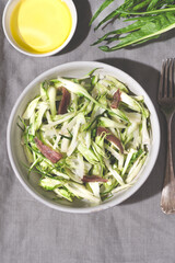 Puntarelle alla romana or asparagus Catalonian chicory salad with anchovy dressing and olive oil,...